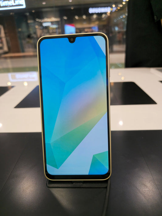 Samsung Galaxy A16 5G 128GB - factory unlocked - front view with gold-toned frame on display stand